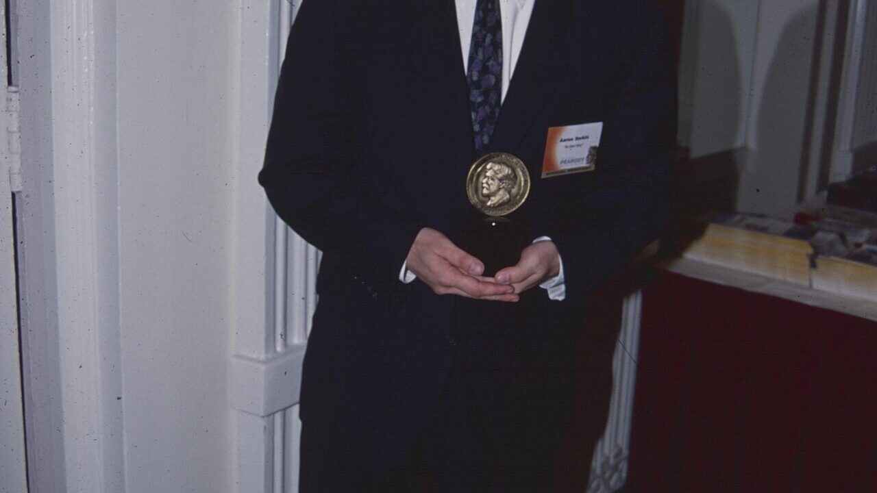 Writer and director Aaron Sorkin holding an award