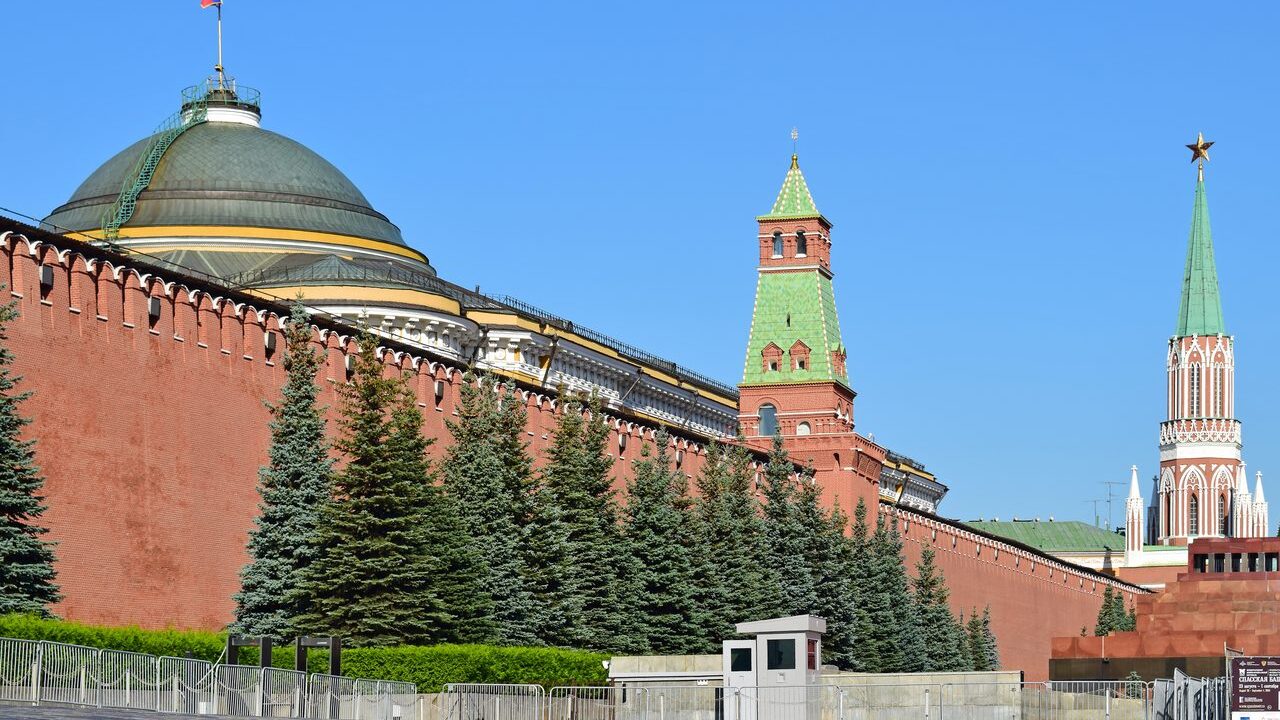 Kremlin wall and red towers under a blue sky in Moscow