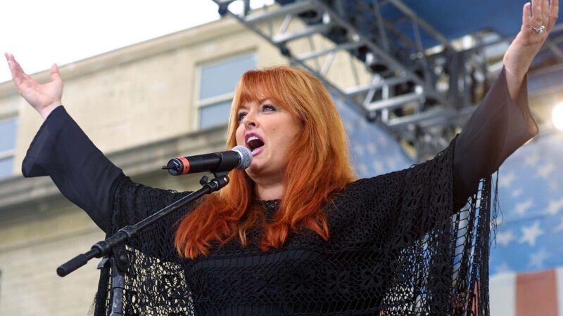 Wynonna Judd performing on stage at a U.S. Army concert at the Pentagon
