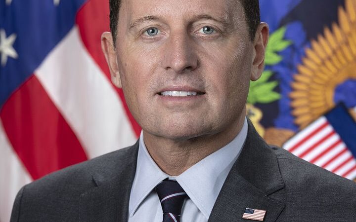 Official portrait of Ric Grenell in a suit